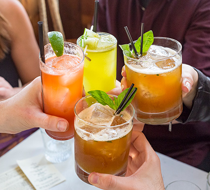 A group of friends toasting with refreshing drinks